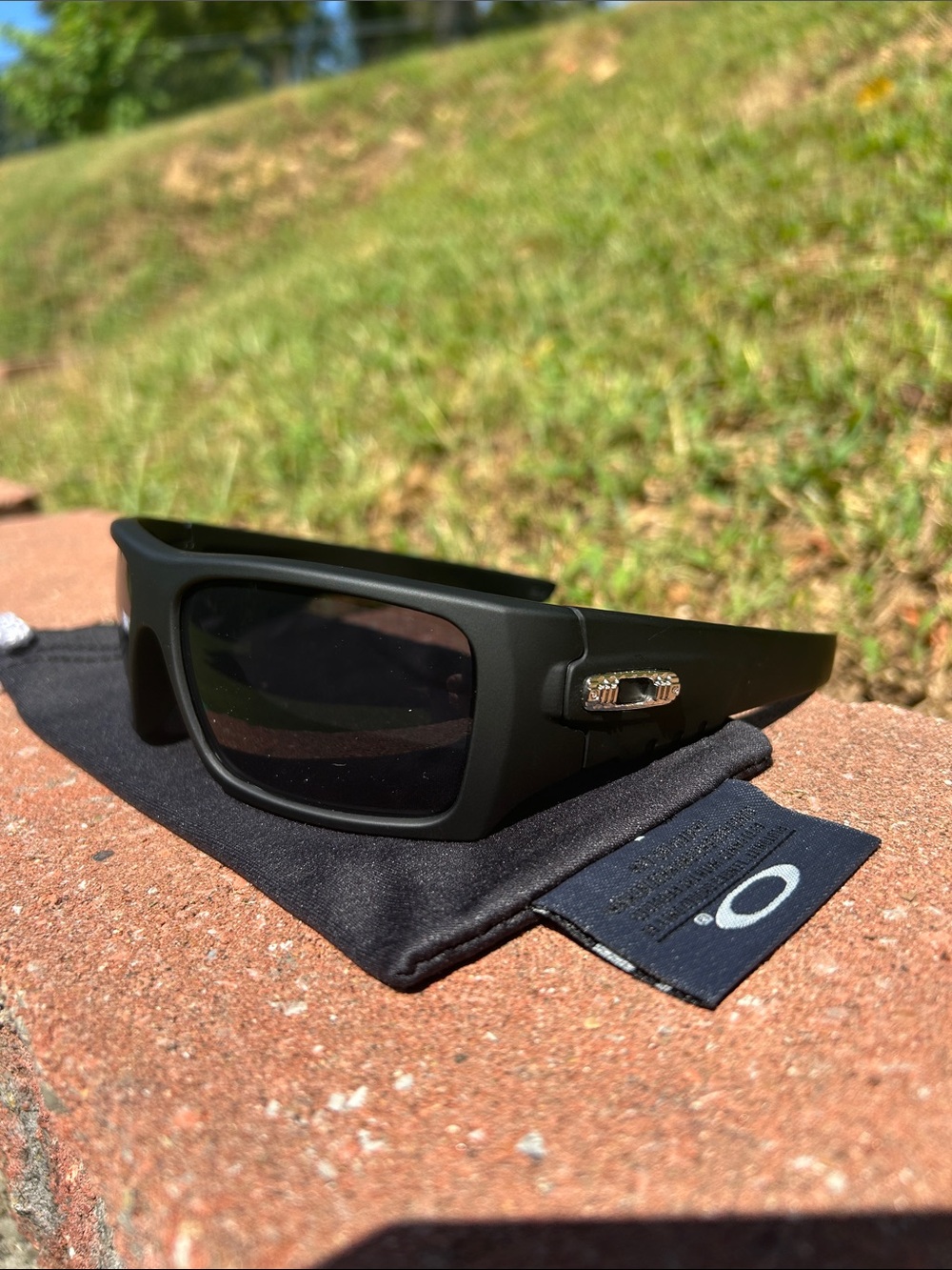 Oakley Men’s Matte Black Sunglasses with Dark Lenses and Silver Logo